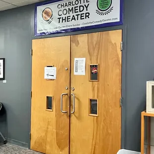 two wooden doors with signs on them