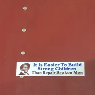 a sticker on a red door