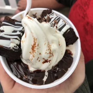 a person holding a bowl of ice cream