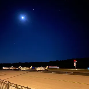 a full moon over the airport