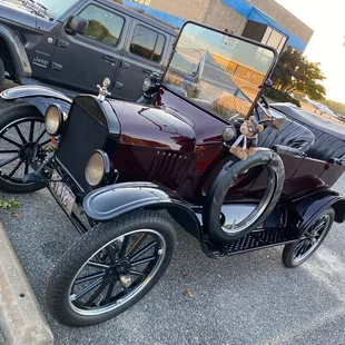 an old car parked in a parking lot
