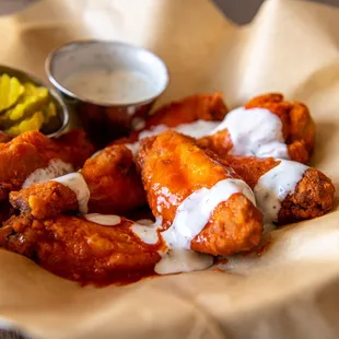 a plate of chicken wings with ranch dressing