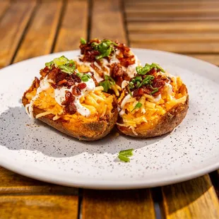 two baked potatoes on a plate