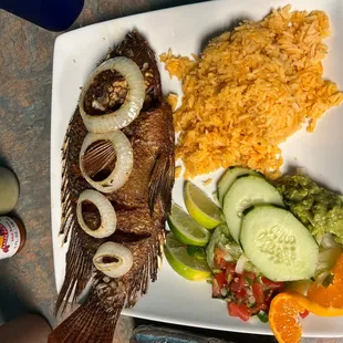 a plate of fish and rice