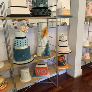 a variety of cakes displayed on shelves