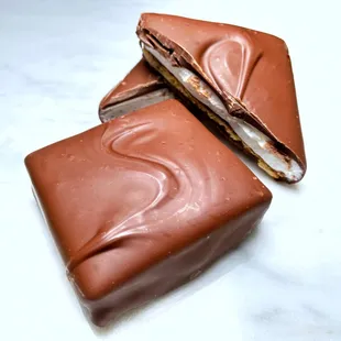 a piece of chocolate with a bite taken out of it