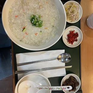 a bowl of soup and spoons on a tray
