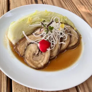 a plate of food on a wooden table
