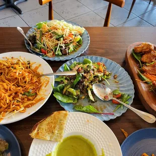 Pad Thai Noodles, beef steak salad (sorry we had already been digging in), fried chicken wings, Thai style papaya salad, &amp; roti with curry.