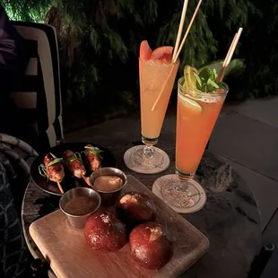 Pork belly skewers, pretzels, drinks