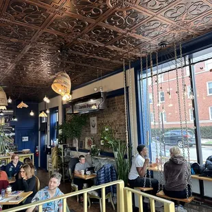 people sitting at tables in a cafe