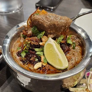 Mutton haleem- Allow it to cool down a bit then squeeze lime on it and mix. Beautiful flavors!