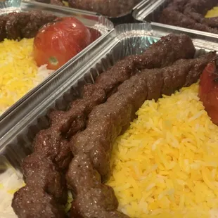 Beef kebabs we other saffron rice and grilled tomato