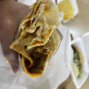 a hand holding a sandwich