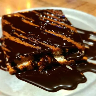 a piece of cake with chocolate sauce drizzled over it