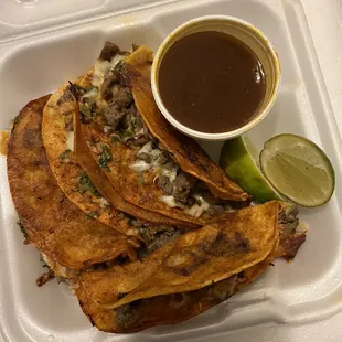 4 Birria Steak Tacos (I don't know what the liquid in the cup is).