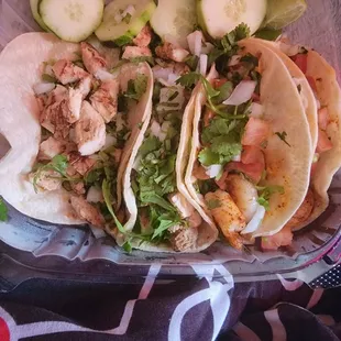 Two chicken and two shrimp street tacos.