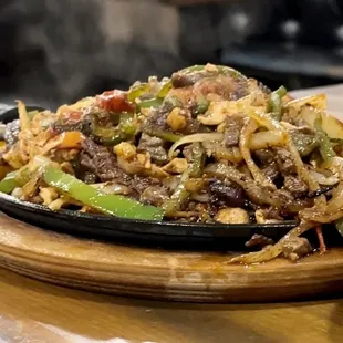 Chicken and steak fajita. Sizzling hot.
