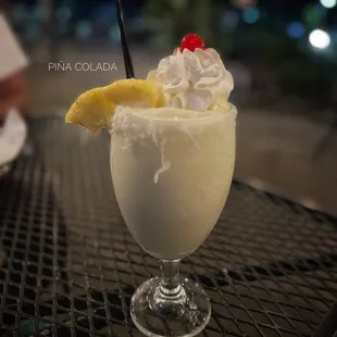 a drink with whipped cream and a pineapple garnish