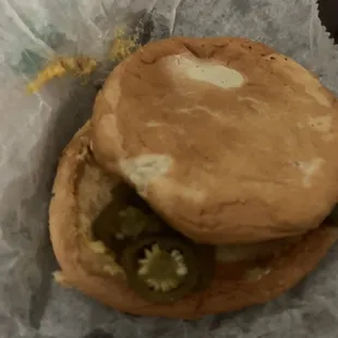 a hamburger with pickles on it