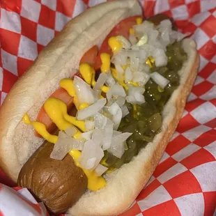 a hot dog with onions and mustard