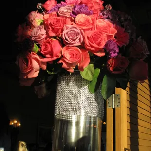 Flower arrangements in tall large vases.