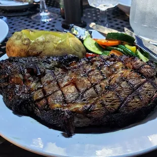 a large steak on a white plate
