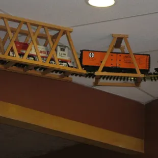 Model train runs along the ceiling