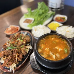 Spicy Pork Bulgogi Dinner Plate, tofu stew, rice, lettuce and traditional Korean sides