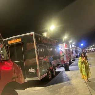a woman standing in front of a food truck