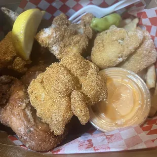 Fried fish with fried chicken wings