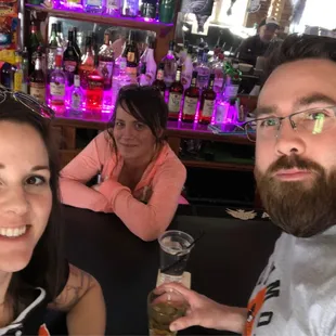 a man and a woman sitting at a bar