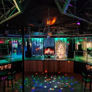 a dance floor with lights and a christmas tree