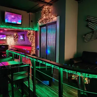 a bar with neon lights and a couch