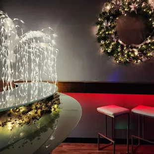 a lighted bar with a wreath on the wall