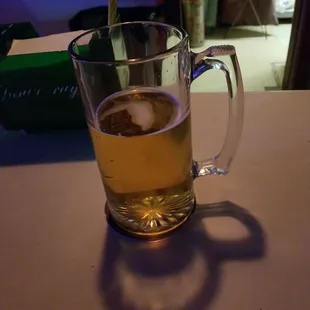 a glass of beer on a table