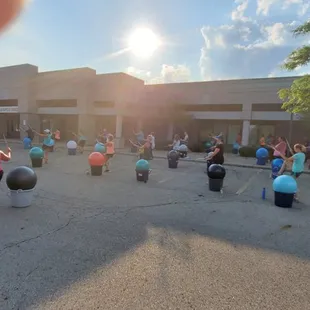 a group of people walking in a parking lot