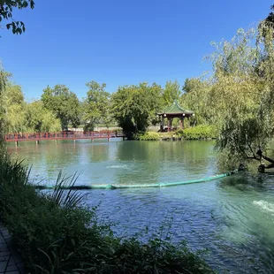a view of a pond and pavilion