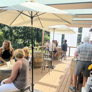 a group of people sitting at a table under an umbrella