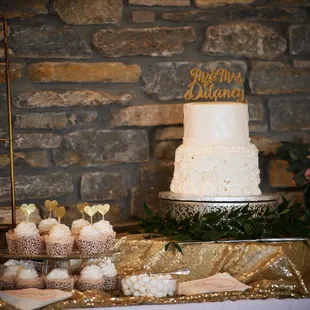 a wedding cake and cupcakes