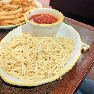 Kids&apos; menu - Spaghetti and a meatball, with fries on the side.