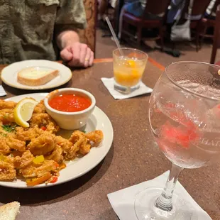 a plate of food and a glass of wine