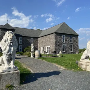 a stone lion statue in front of a stone building
