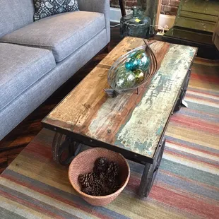The coffee table we almost got. Repurposed teak, industrial cart with wheels. Way cool.