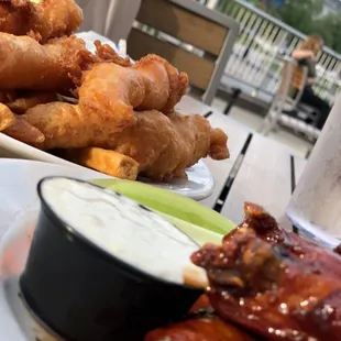 a plate of chicken wings and dipping sauce