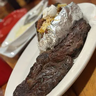Ribeye w/loaded baked potato ... Queso Fundido in the background.