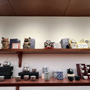a shelf of pottery on display