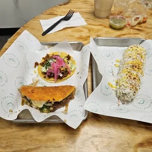 Al pastor (top), birria taco (bottom), elote (right)