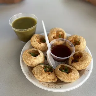 a plate of food with dipping sauce