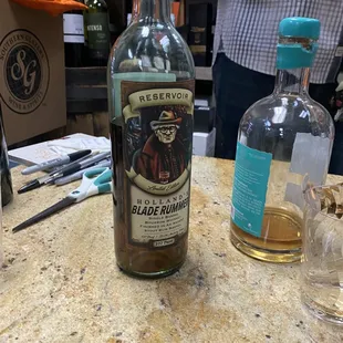 a bottle and a glass on a counter